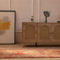 Handwoven brown floral Persian runner rug in wool and cotton, featuring intricate maximalist patterns on a wooden floor.