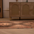 Vintage 3x11 ft Turkish runner rug in brown and orange with geometric tribal patterns, handwoven from wool and cotton.