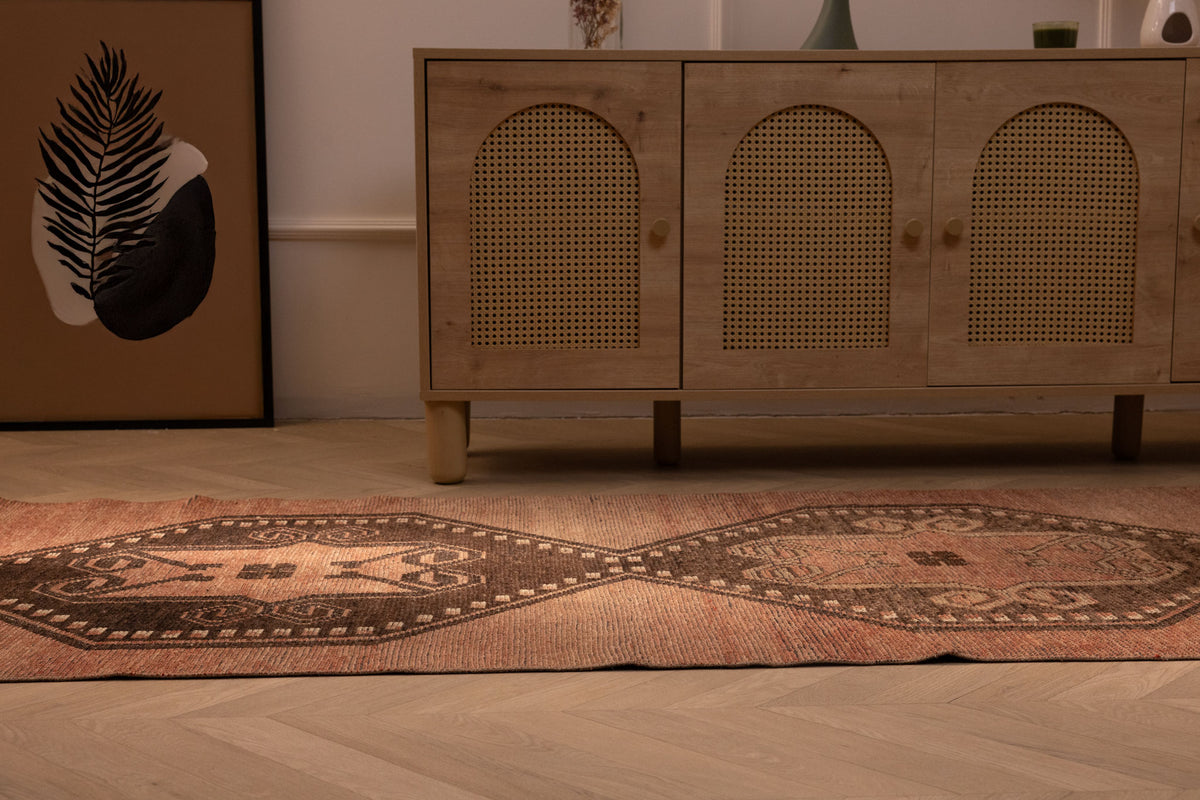Vintage 3x11 ft Turkish runner rug in brown and orange with geometric tribal patterns, handwoven from wool and cotton.