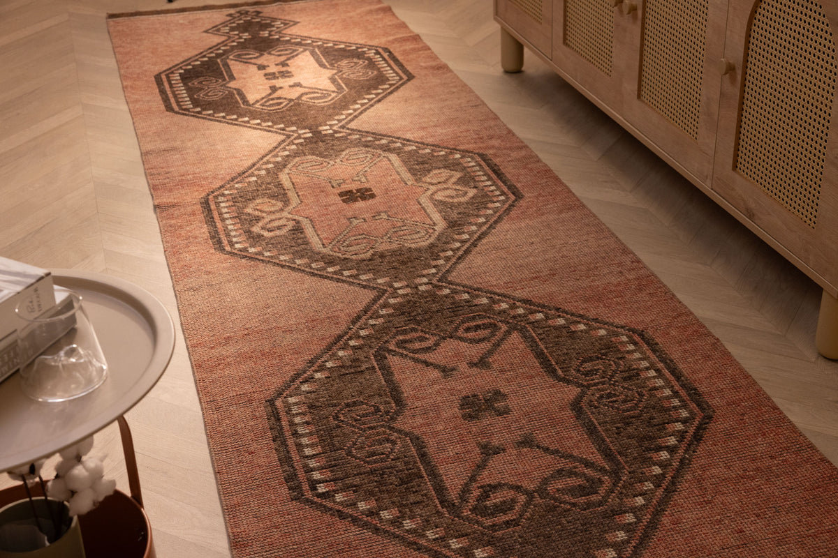 Handwoven 3x11 ft vintage Turkish runner rug in brown and orange with geometric tribal patterns and wool-cotton blend.