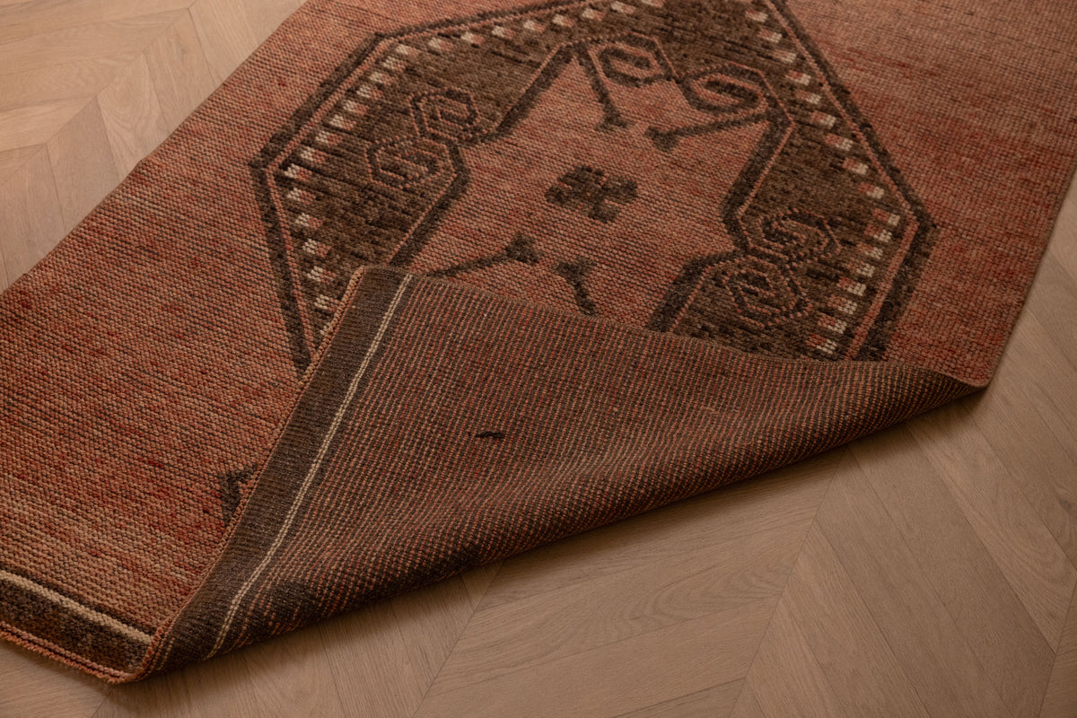Handwoven vintage Turkish runner rug in brown and orange with geometric patterns, 3x11 ft wool and cotton blend.