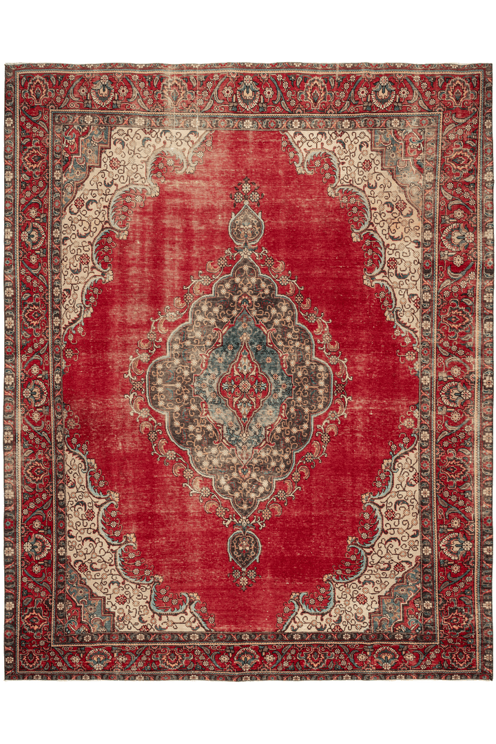 Oversized 9x11ft handmade wool and cotton Persian rug featuring a red floral pattern with traditional bohemian motifs.