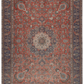 Oversized 9.7x13 ft handmade wool and cotton Persian-style rug featuring red and navy floral patterns.