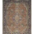 Oversized Persian-style wool and cotton rug in orange and navy with intricate floral patterns and traditional motifs.
