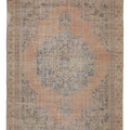 A distressed vintage-style oriental rug with a central medallion, featuring a dusty peach-pink field, faded blue motifs, and a beige border.