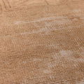 Close-up of a vintage beige and brown hand-woven Turkish wool runner rug with a textured geometric pattern.