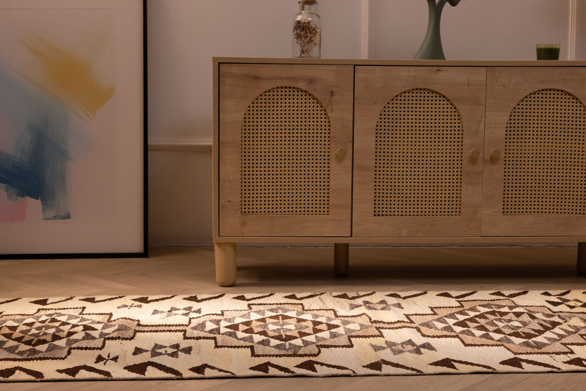 Handmade white and brown wool-cotton Persian-style kilim runner with geometric patterns in a farmhouse interior.