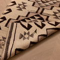 Handmade white and brown wool-cotton flatweave runner rug with geometric Persian-style patterns.