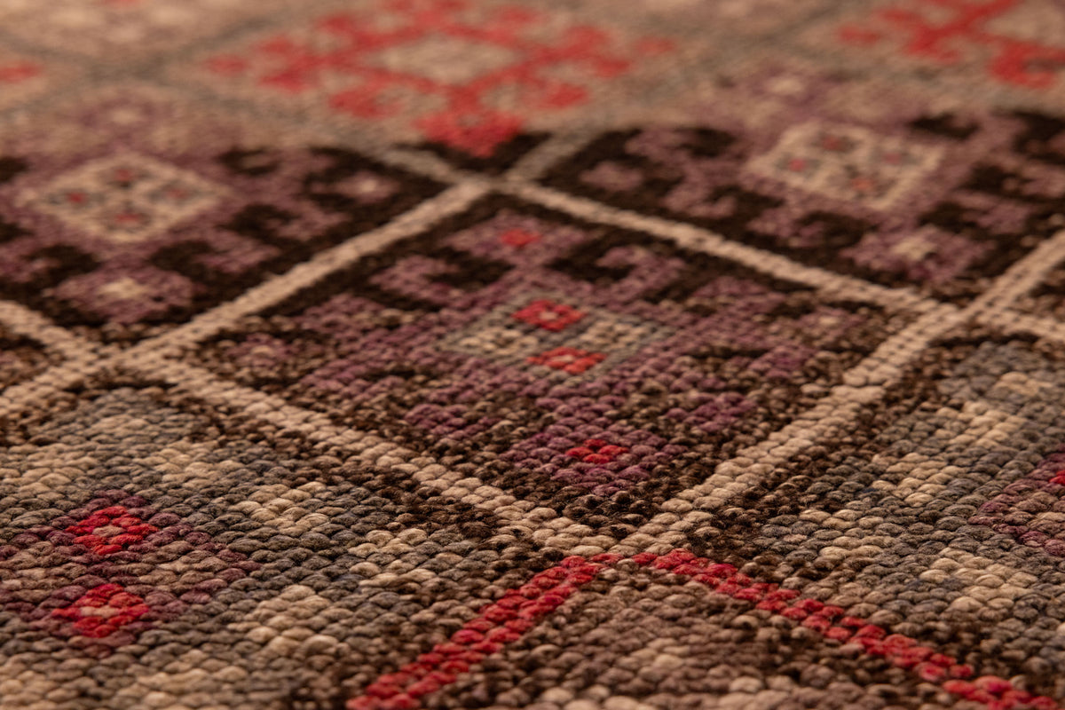 Handmade brown wool and cotton runner rug featuring a geometric, bohemian-style maximalist pattern.