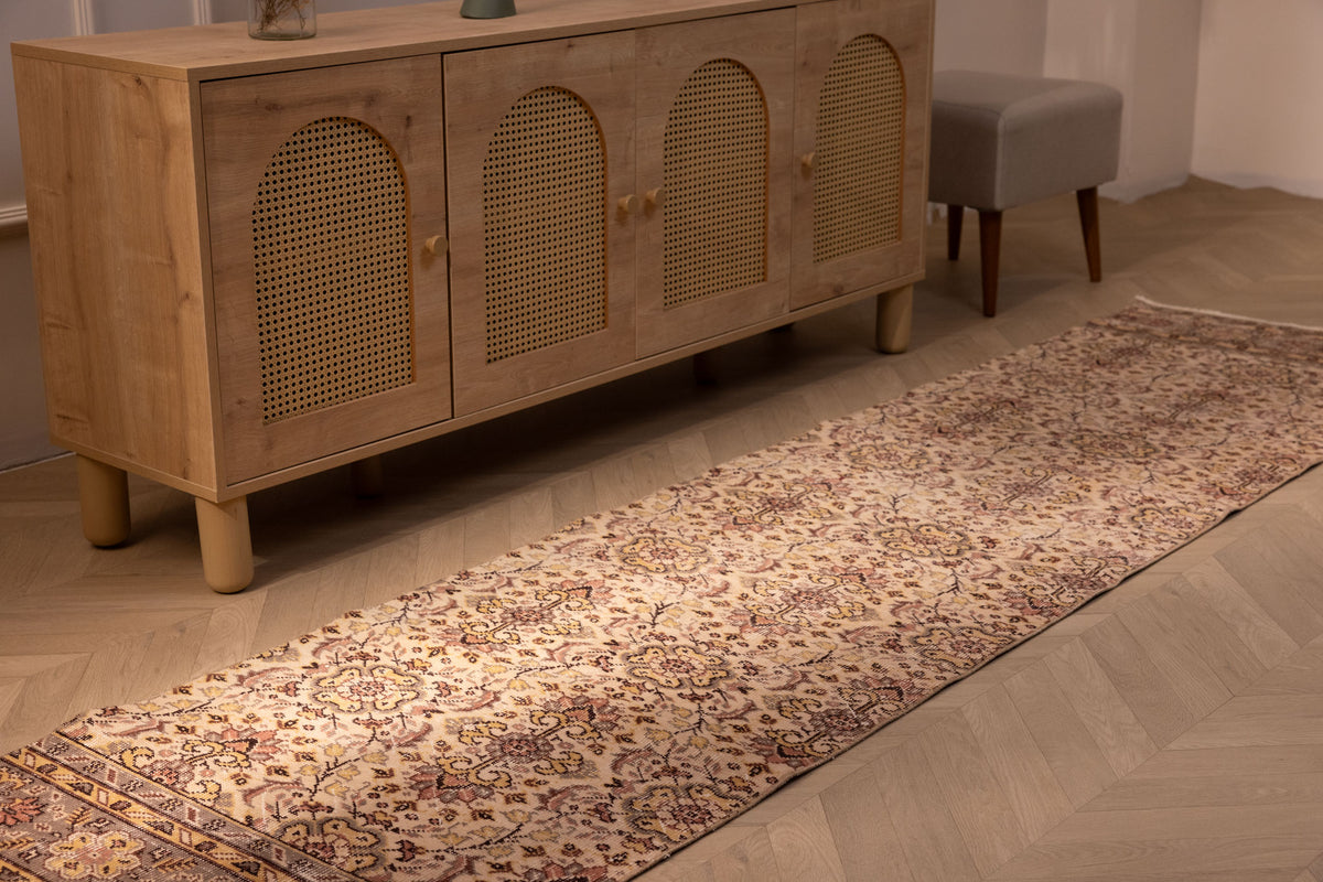 Vintage Isparta wool and cotton runner rug with white and beige floral patterns in a farmhouse hallway.