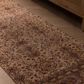 Vintage handmade Isparta wool and cotton runner rug with white and beige floral maximalist patterns on a wooden floor.