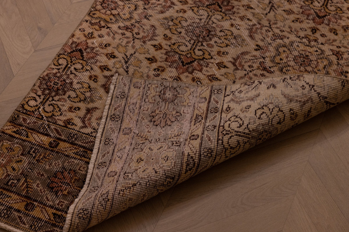 Hand-woven vintage Isparta wool and cotton runner rug in white and beige with intricate floral maximalist patterns.