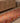 Handmade 3x11 ft Persian-style wool and cotton kilim runner with pink and orange geometric patterns on a wooden floor.