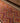 Handmade 3x11 ft wool and cotton Persian-style kilim runner featuring pink and orange geometric patterns.