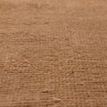 Close-up of a vintage beige and brown hand-woven wool and cotton Turkish runner rug with a low-pile texture.