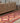 Handmade 3.4x11.3 ft wool and cotton Persian-style kilim runner in vibrant orange and pink geometric patterns.