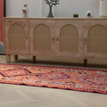 Bohemian 3.4x11.3 ft wool and cotton kilim runner with orange and pink geometric patterns.