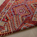 Handmade 3.4x11.3 ft wool and cotton kilim runner with orange and pink geometric maximalist patterns.