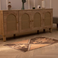 Hand-woven 2x4 ft vintage Turkish wool and cotton doormat with orange and brown geometric patterns.