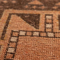 Hand-woven vintage Turkish doormat in orange and brown wool with geometric patterns.