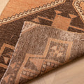 Hand-woven 2x4 ft vintage Turkish doormat in orange and brown wool-cotton with geometric patterns.
