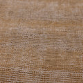 Close-up of a vintage Turkish wool and cotton runner rug in beige and brown with a textured, hand-woven geometric weave.