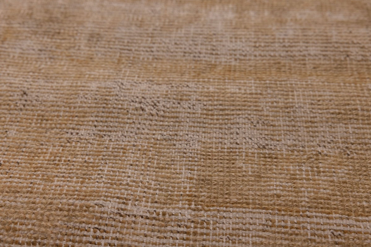 Close-up of a vintage Turkish wool and cotton runner rug in beige and brown with a textured, hand-woven geometric weave.