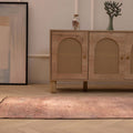 Handmade 2.7x9.5 ft wool and cotton Persian-style runner rug in brown and pink with geometric bohemian patterns.