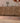 Handmade 2.7x9.5 ft Persian-style runner rug in brown and pink with geometric patterns, crafted from wool and cotton.