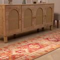 Handmade 2.6 x 13.5 ft Persian-style wool and cotton runner rug in red and orange with maximalist floral patterns.
