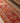 Handmade 13.5ft wool and cotton runner rug in red and orange with a bohemian floral pattern.