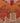 Close-up of a handmade wool and cotton Persian-style runner rug with red, orange, and beige floral patterns.