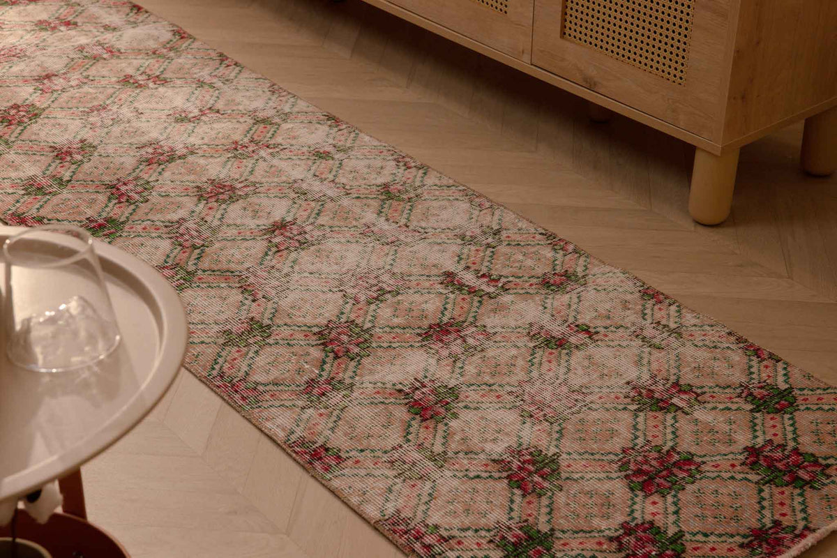 Vintage 2.3x8.6 ft beige Turkish runner rug with distressed floral patterns in wool and cotton.