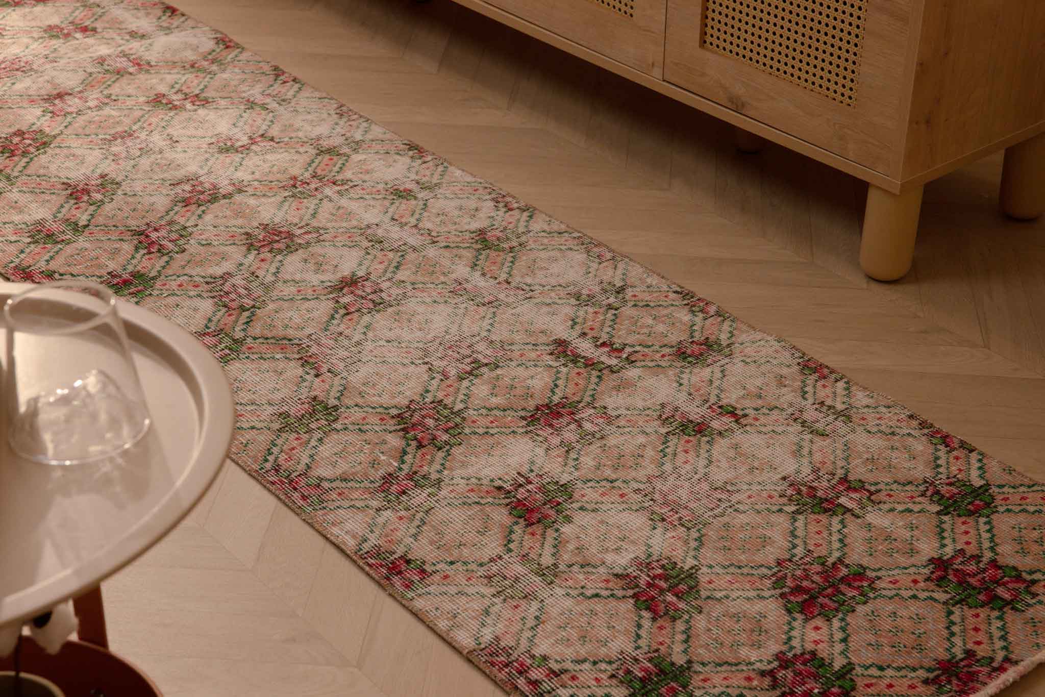 Vintage 2.3x8.6 ft beige Turkish runner rug with distressed floral patterns in wool and cotton.