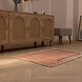 Handmade vintage Isparta wool and cotton rug in red and beige stripes, 2x3 ft, displayed on a wooden floor.
