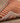Hand-woven 2x3 ft vintage Isparta wool and cotton rug with red and beige stripes on a herringbone wood floor.