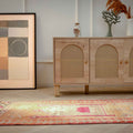 Handmade 2.7x9.9 ft wool and cotton Persian runner rug in bohemian orange and yellow with human-figured patterns.