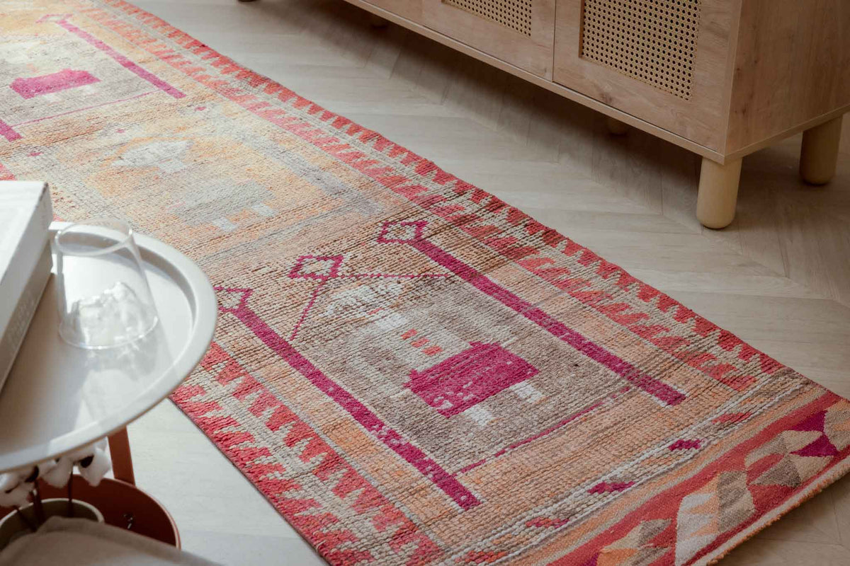 Handmade 2.7x9.9 ft wool and cotton runner rug with orange and yellow bohemian human-figured Persian patterns.