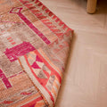 Handmade 2.7x9.9 ft wool and cotton runner rug in orange and yellow with bohemian human-figured patterns.