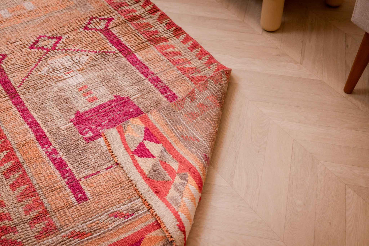 Handmade 2.7x9.9 ft wool and cotton runner rug in orange and yellow with bohemian human-figured patterns.