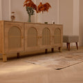Vintage beige and brown Turkish runner rug with distressed geometric patterns on a light wood floor.