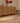 Vintage beige and brown Turkish runner rug with distressed geometric patterns on a light wood floor.