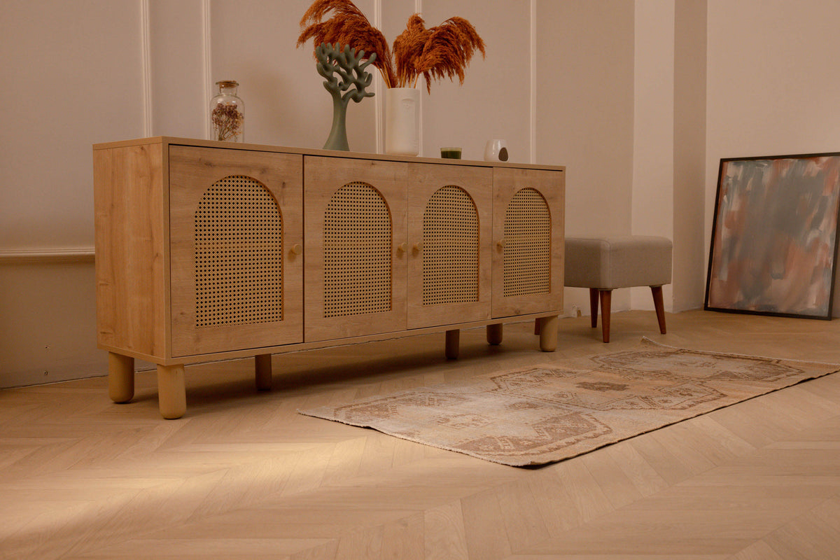 Vintage beige and brown Turkish runner rug with distressed geometric patterns on a light wood floor.