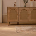 Hand-woven vintage Turkish runner rug in beige and brown with distressed geometric patterns on a herringbone wood floor.