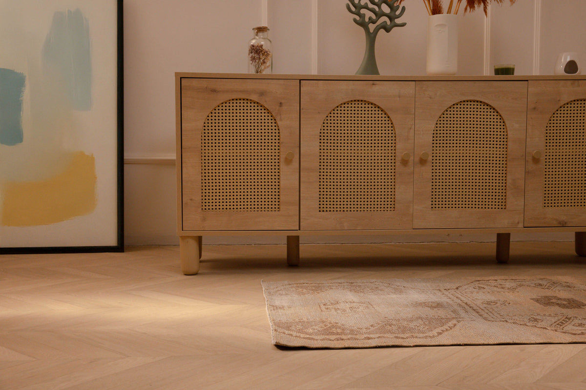 Hand-woven vintage Turkish runner rug in beige and brown with distressed geometric patterns on a herringbone wood floor.