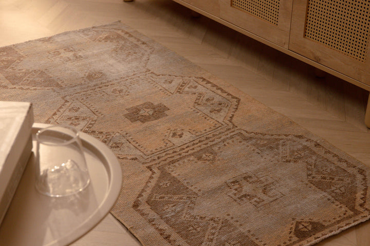 Vintage beige and brown geometric Turkish runner rug, hand-woven in wool and cotton with a distressed farmhouse style.
