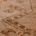 Close-up of a vintage hand-woven Turkish runner rug in beige and brown with a distressed geometric wool-cotton weave.