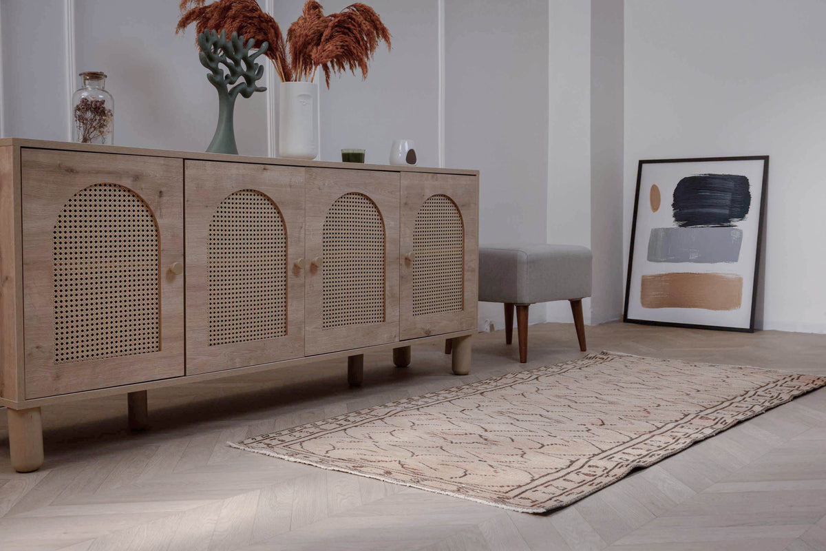 Hand-woven 3x6 ft beige vintage Turkish rug with distressed minimalist patterns in a modern farmhouse living room.