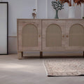 Hand-woven beige vintage Turkish area rug with distressed minimalist patterns on a light herringbone wood floor.