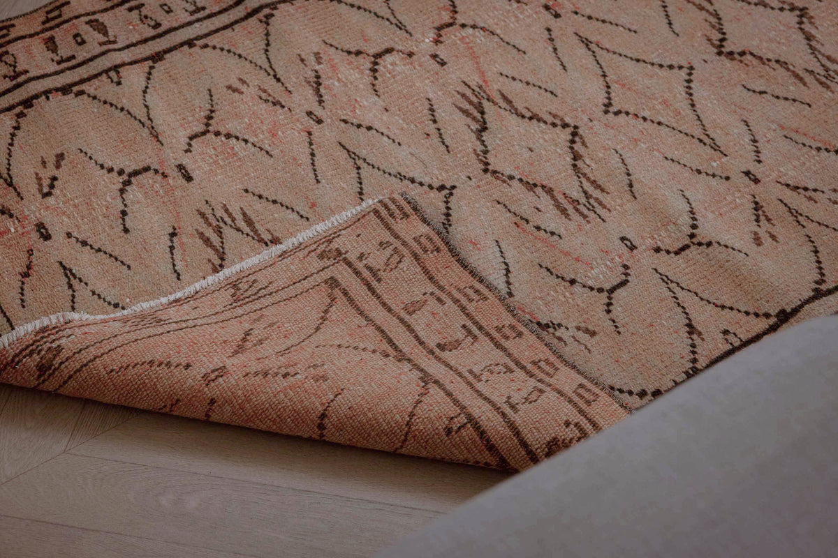 Hand-woven beige vintage Turkish rug with distressed minimalist patterns and wool-cotton blend texture.